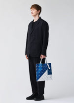 A model wears the BAO BAO ISSEY MIYAKE SIGN tote.