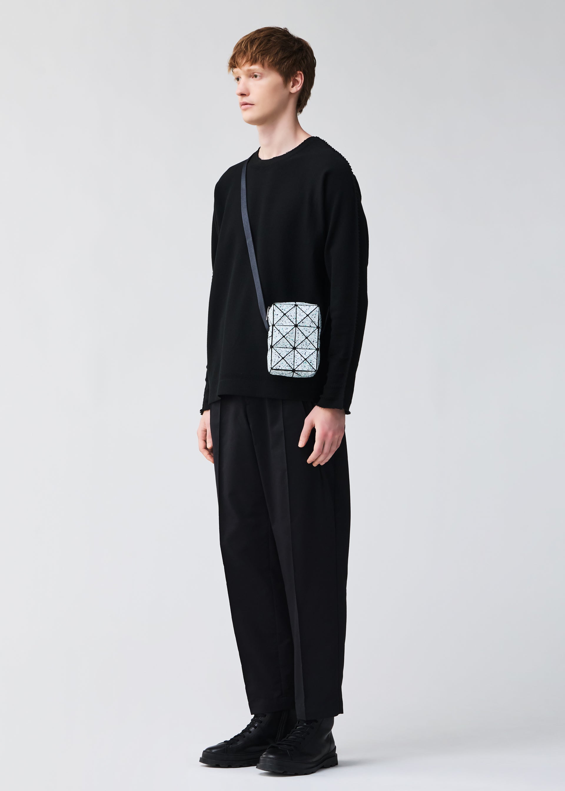 A model wears the BAO BAO ISSEY MIYAKE CITY shoulder bag.