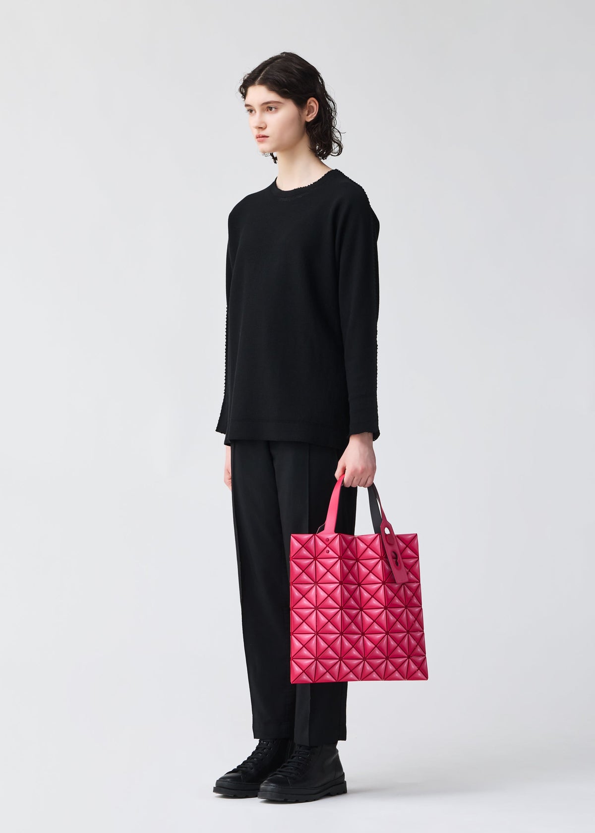 A model wears the BAO BAO ISSEY MIYAKE MINIATURE miniature-tote-mint-green.