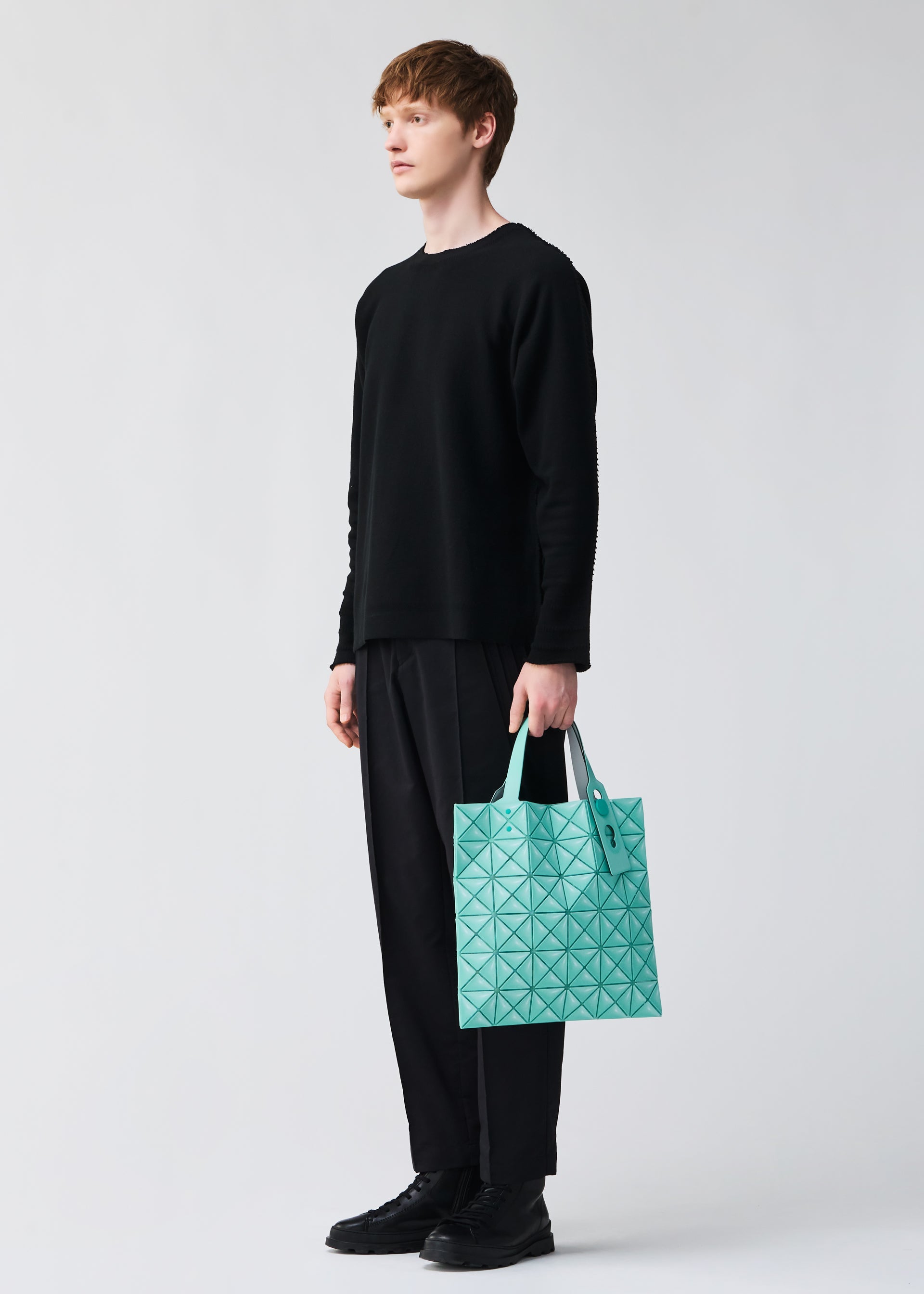 A model wears the BAO BAO ISSEY MIYAKE MINIATURE miniature-tote-mint-green.