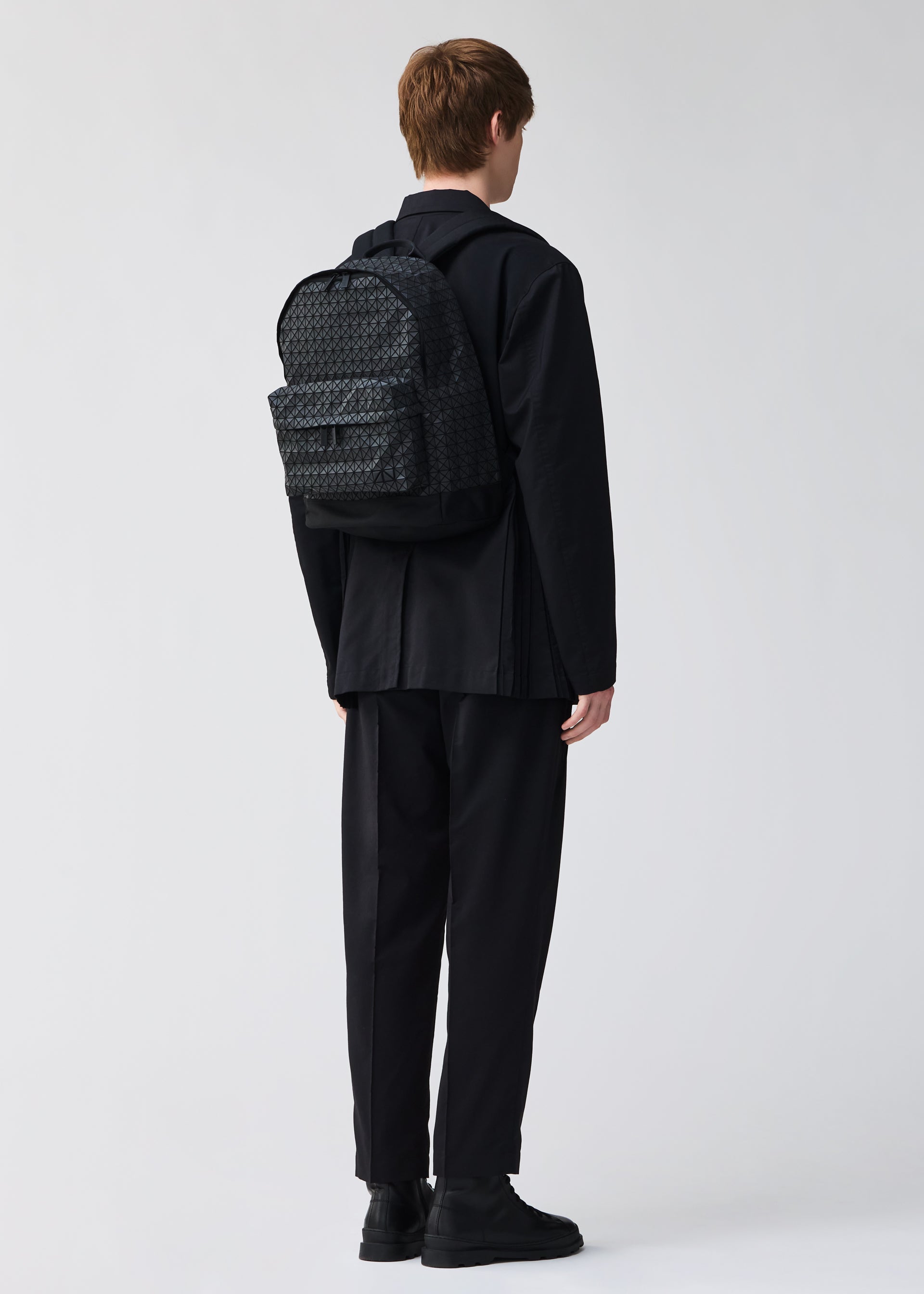A model wears the BAO BAO ISSEY MIYAKE DAYPACK backpack.