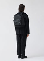 A model wears the BAO BAO ISSEY MIYAKE DAYPACK backpack.