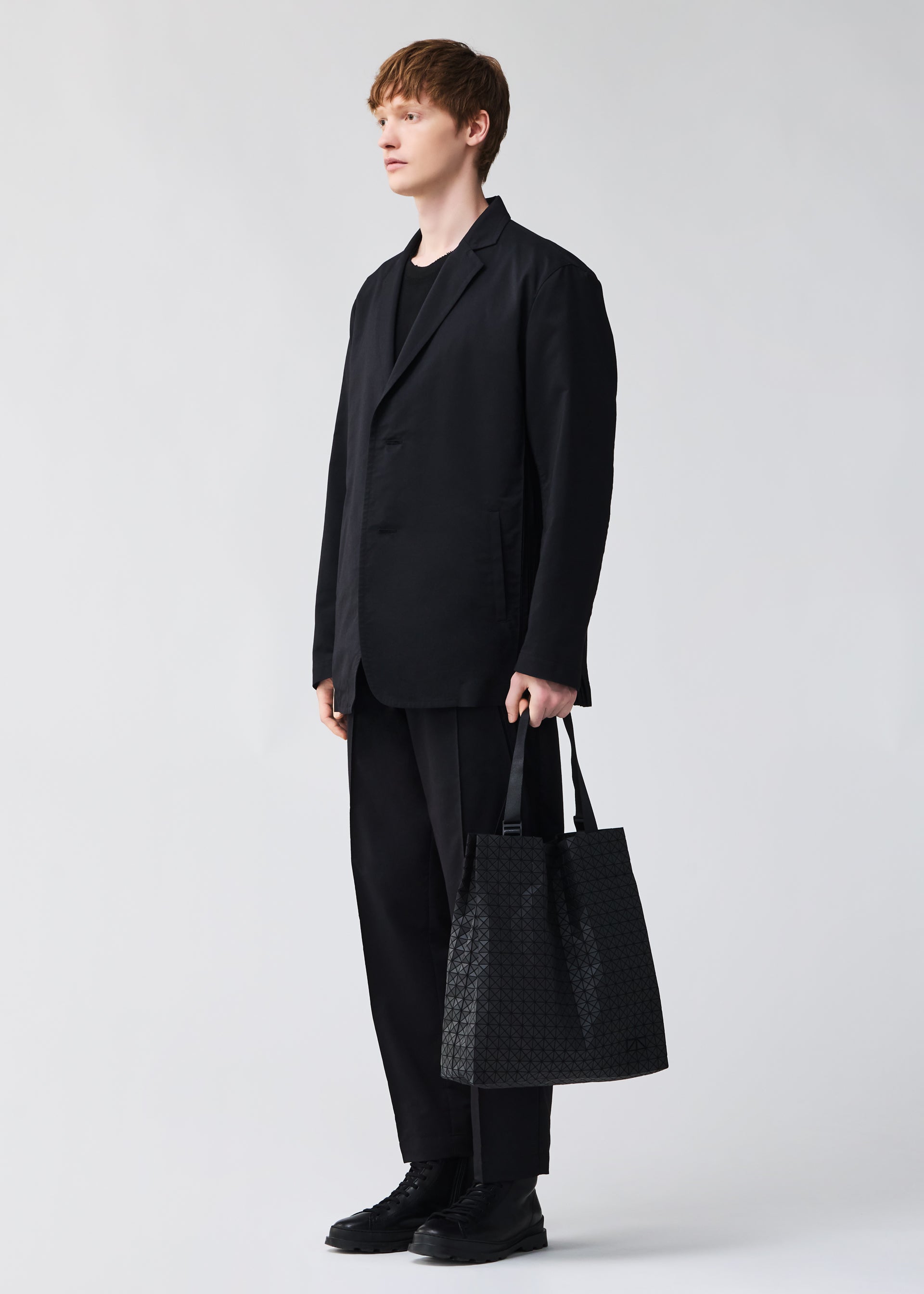 A model wears the BAO BAO ISSEY MIYAKE CART S tote.