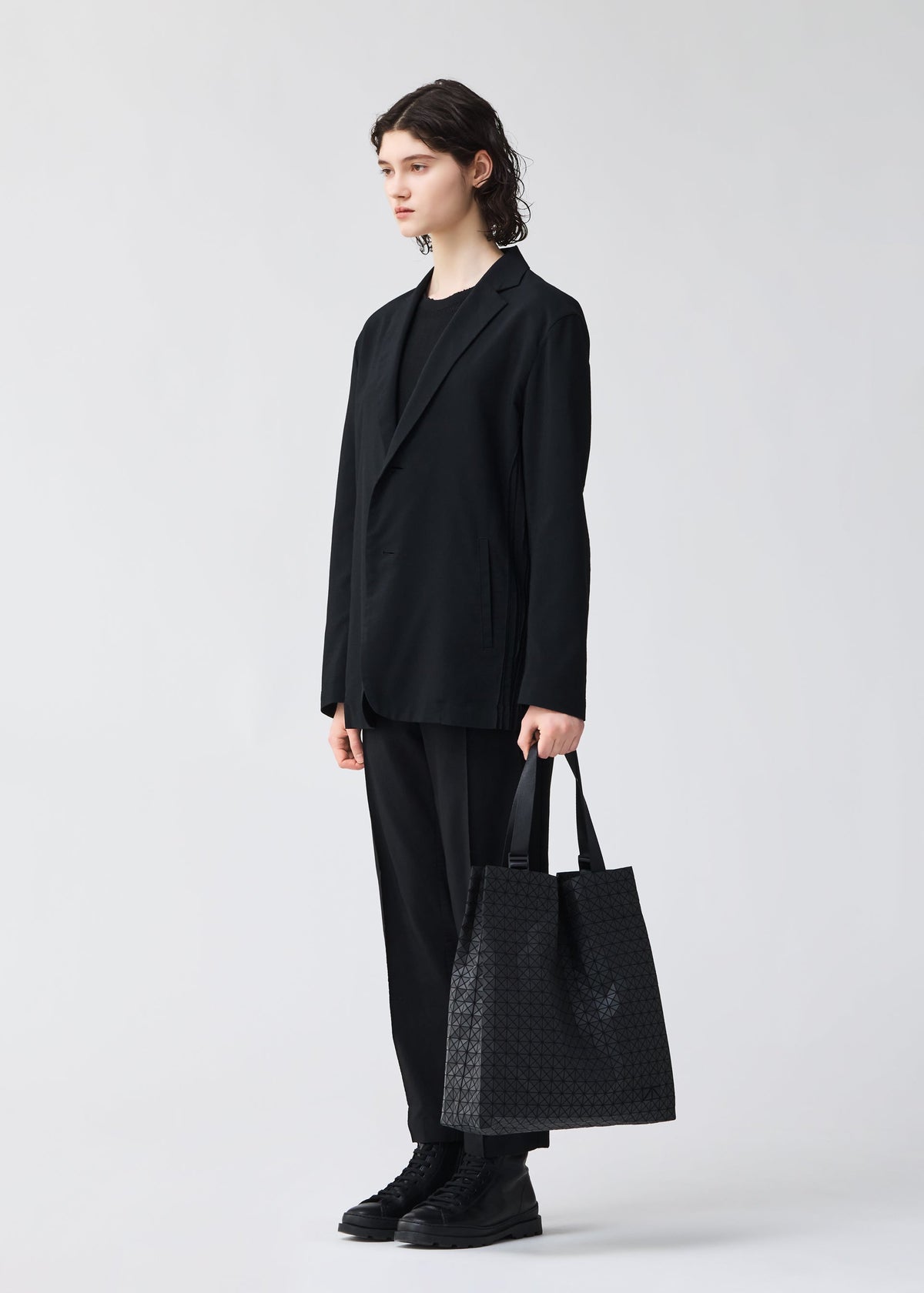 A model wears the BAO BAO ISSEY MIYAKE CART S tote.