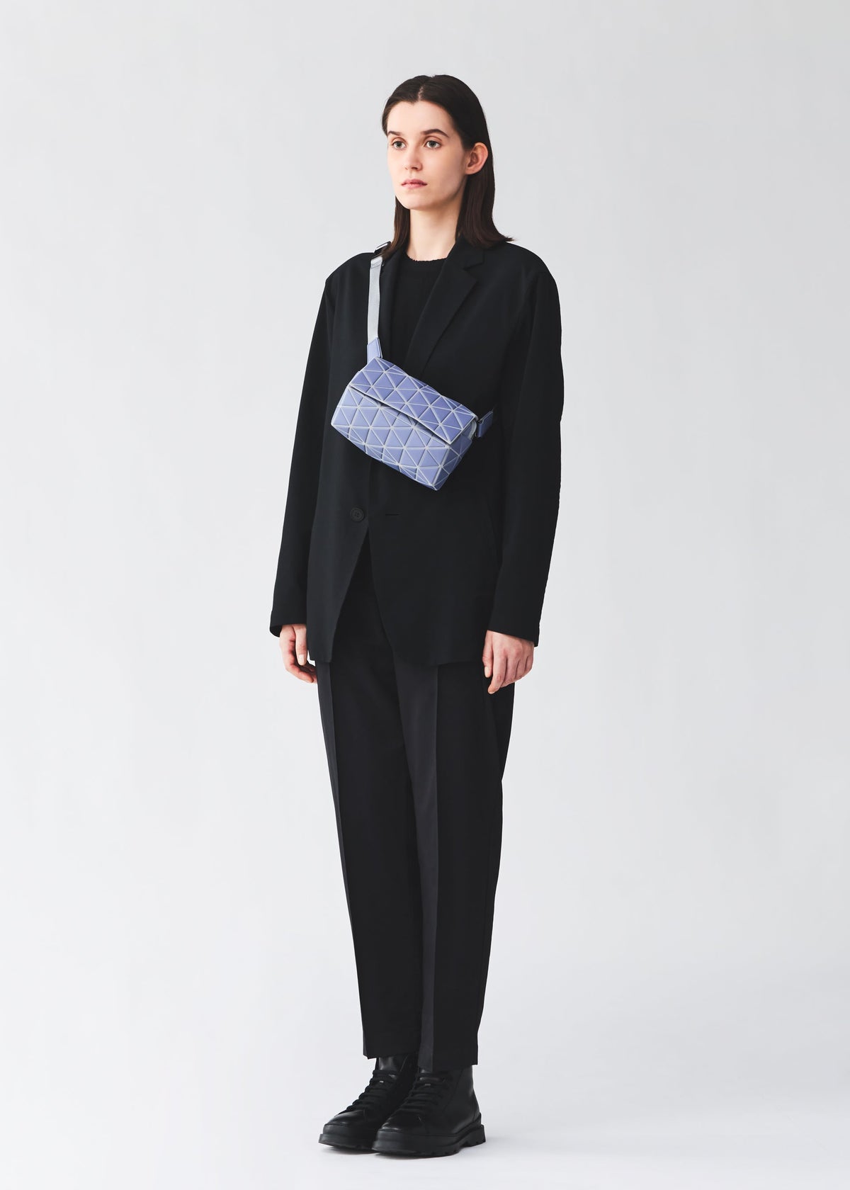 A model wears the BAO BAO ISSEY MIYAKE HEXAGON hexagon-crossbody-matte-black.