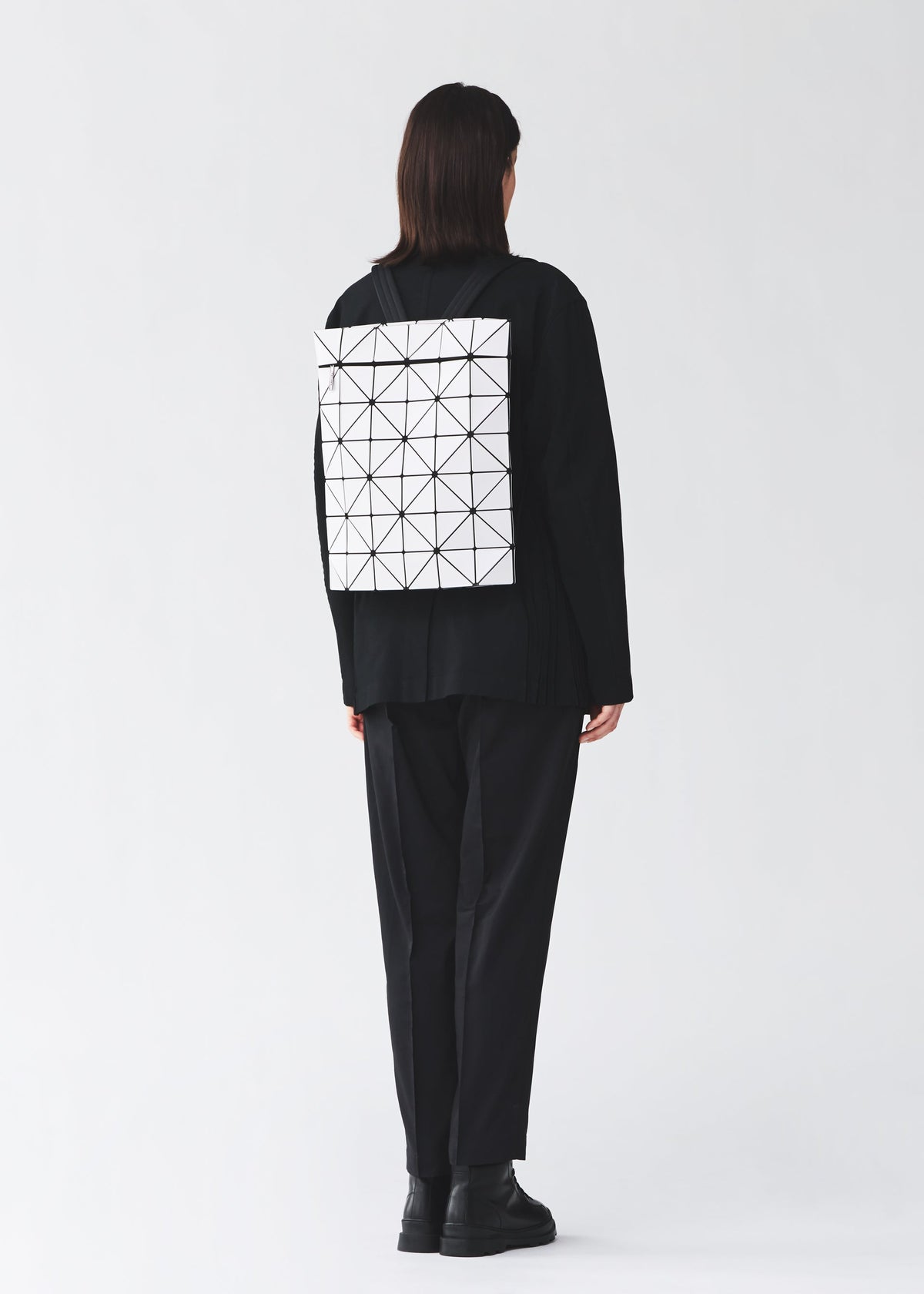 A model wears the BAO BAO ISSEY MIYAKE BLOCKY blocky-adjustable-backpack-matte-black.