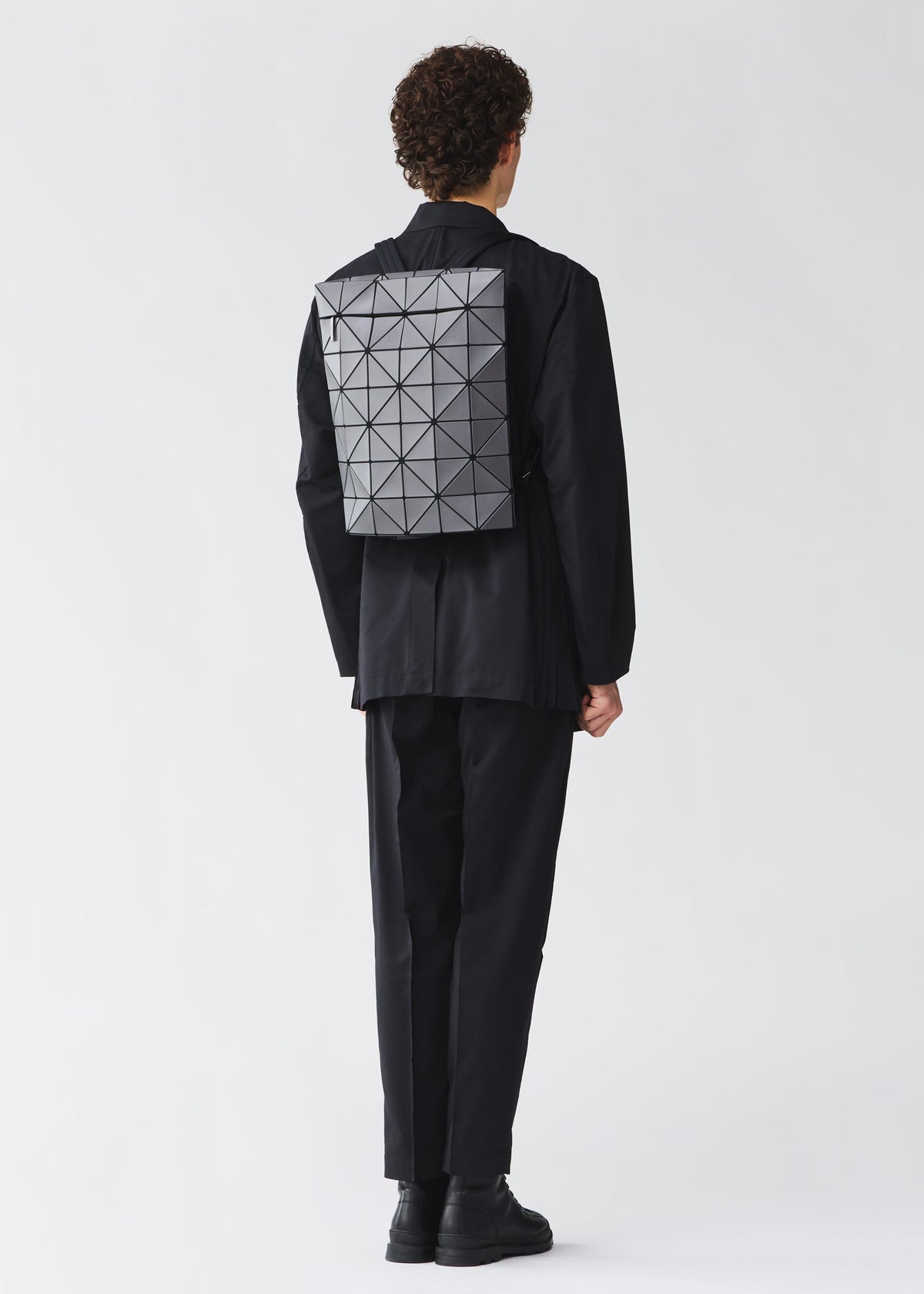 A model wears the BAO BAO ISSEY MIYAKE BLOCKY blocky-adjustable-backpack-matte-black.