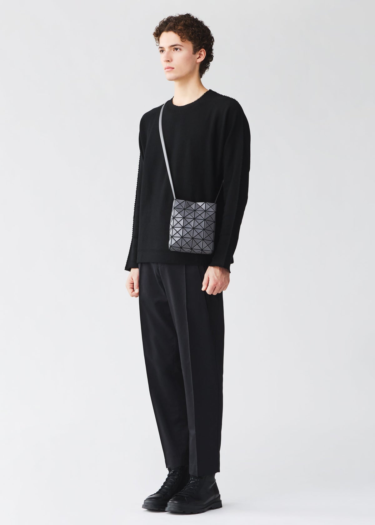 A model wears the BAO BAO ISSEY MIYAKE PRISM MATTE prism-matte-shoulder-bag-matte-black-1.