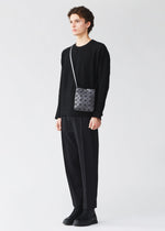 A model wears the BAO BAO ISSEY MIYAKE PRISM MATTE prism-matte-shoulder-bag-matte-black-1.