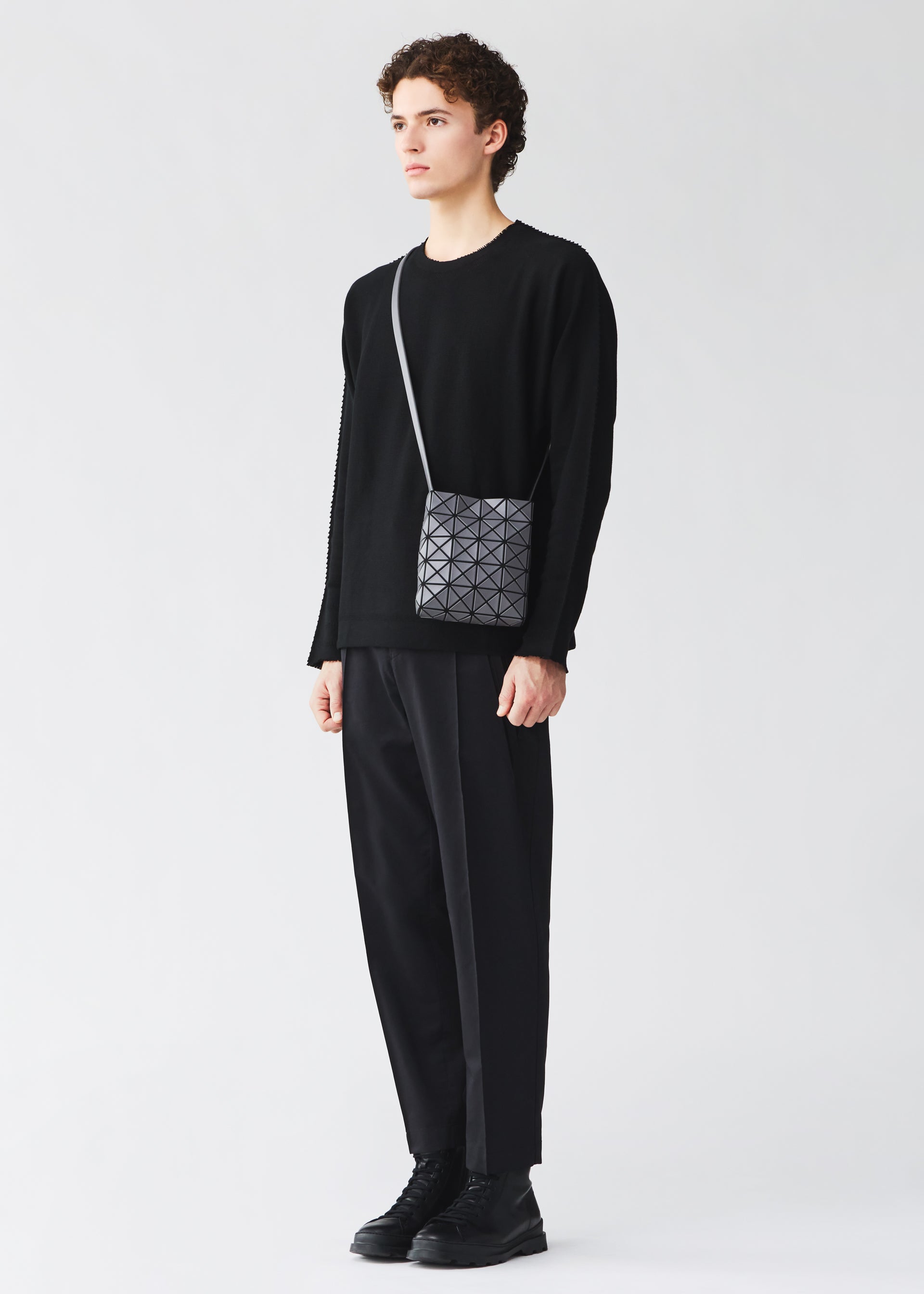 A model wears the BAO BAO ISSEY MIYAKE PRISM MATTE prism-matte-shoulder-bag-matte-black-1.