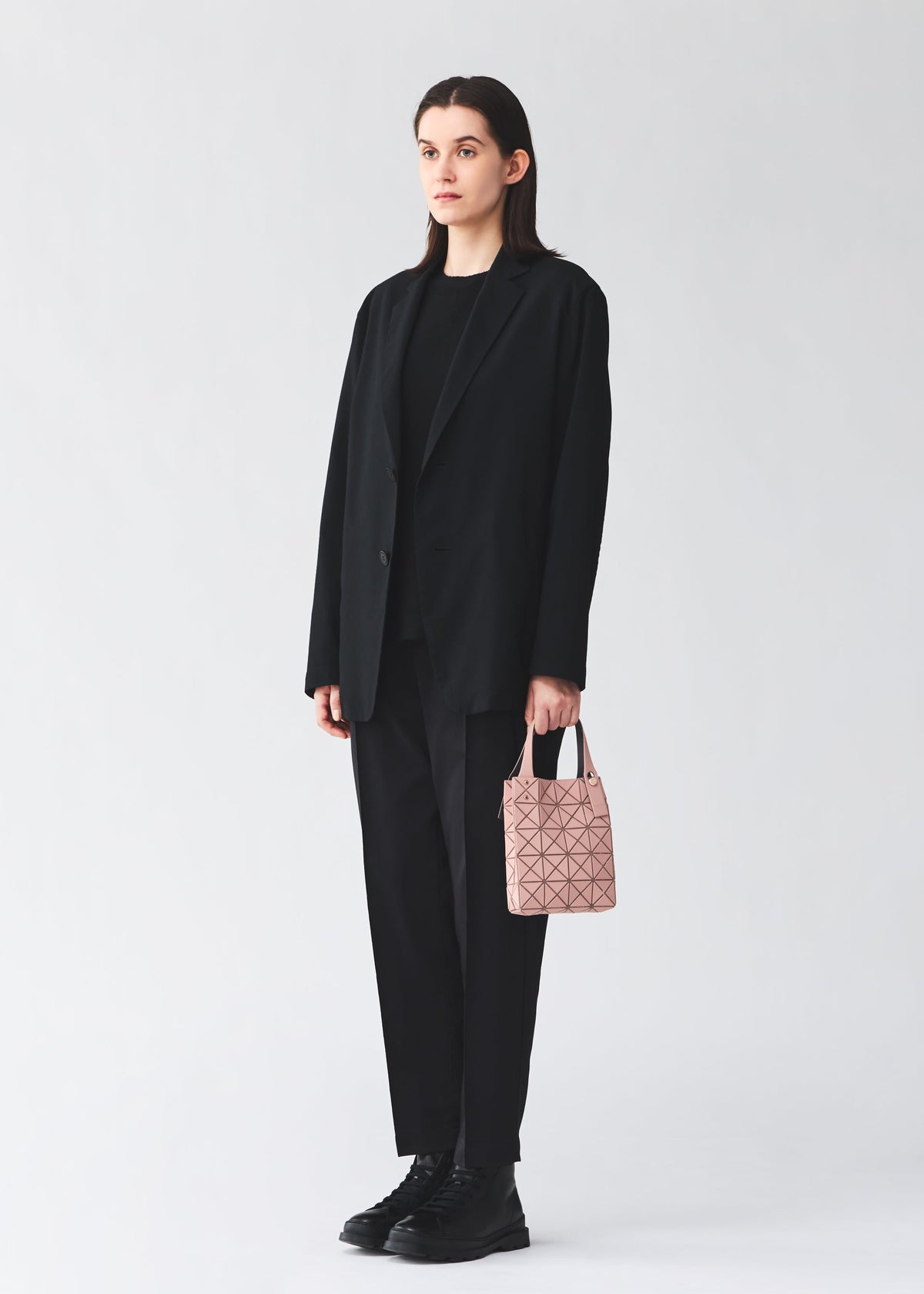 A model wears the BAO BAO ISSEY MIYAKE PRISM PLUS prism-plus-tote-smoky-pink.