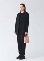 A model wears the BAO BAO ISSEY MIYAKE PRISM PLUS prism-plus-tote-smoky-pink.