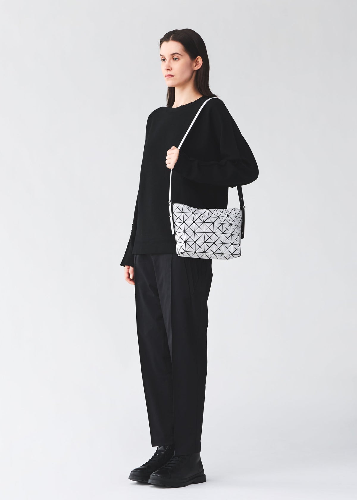 A model wears the BAO BAO ISSEY MIYAKE MUSETTE musette-shoulder-bag-light-brown.