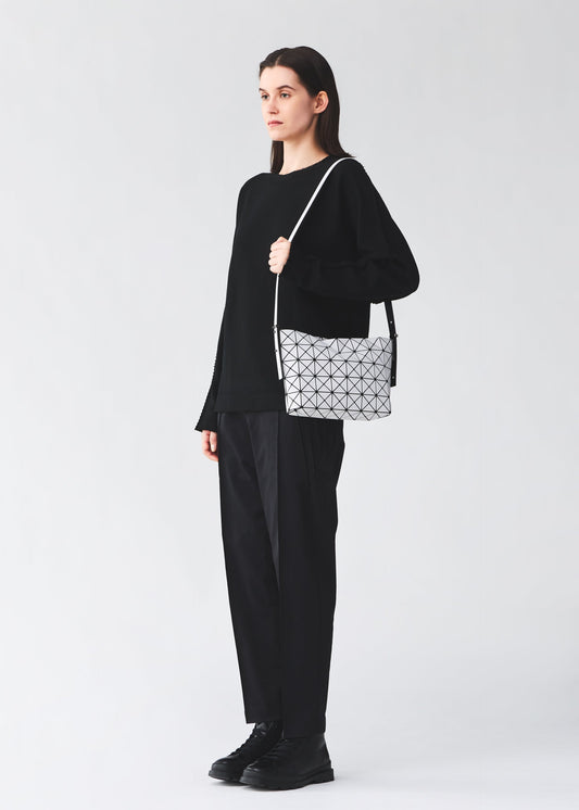 A model wears the BAO BAO ISSEY MIYAKE MUSETTE musette-shoulder-bag-light-brown.