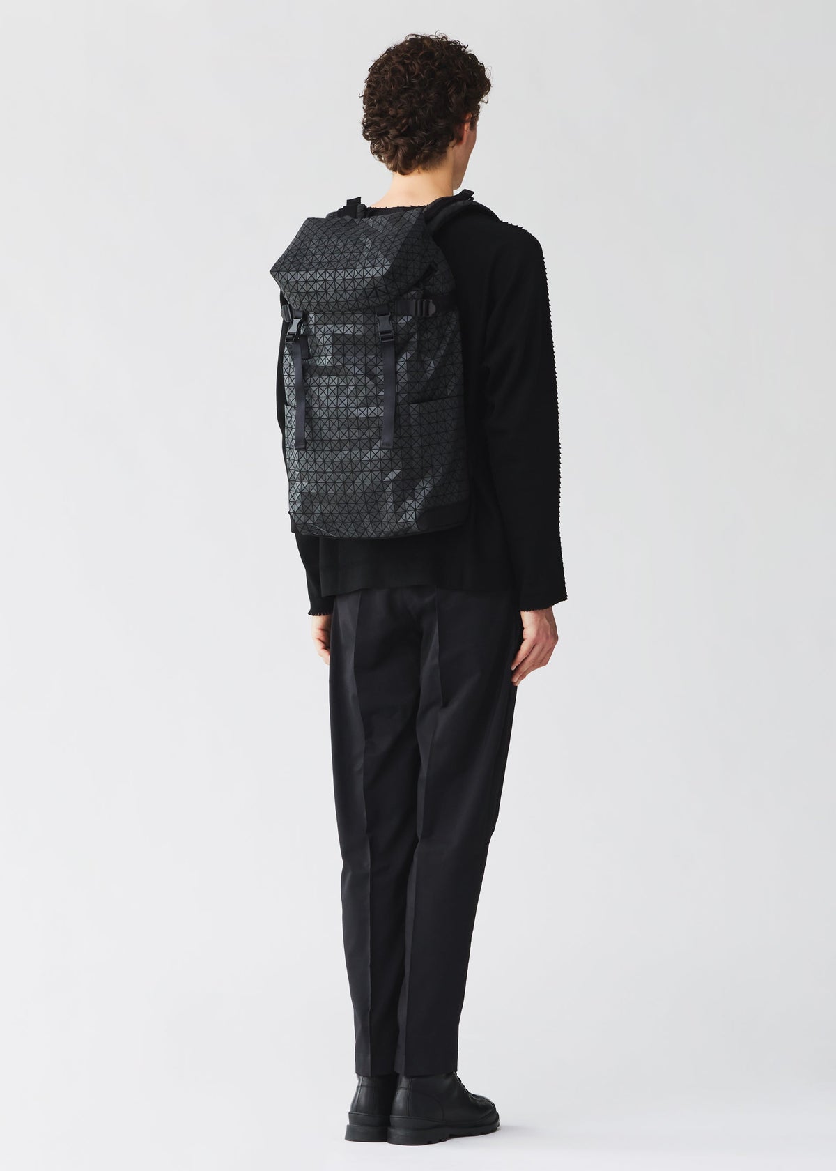 A model wears the BAO BAO ISSEY MIYAKE HIKER hiker-backpack-matte-black-3.