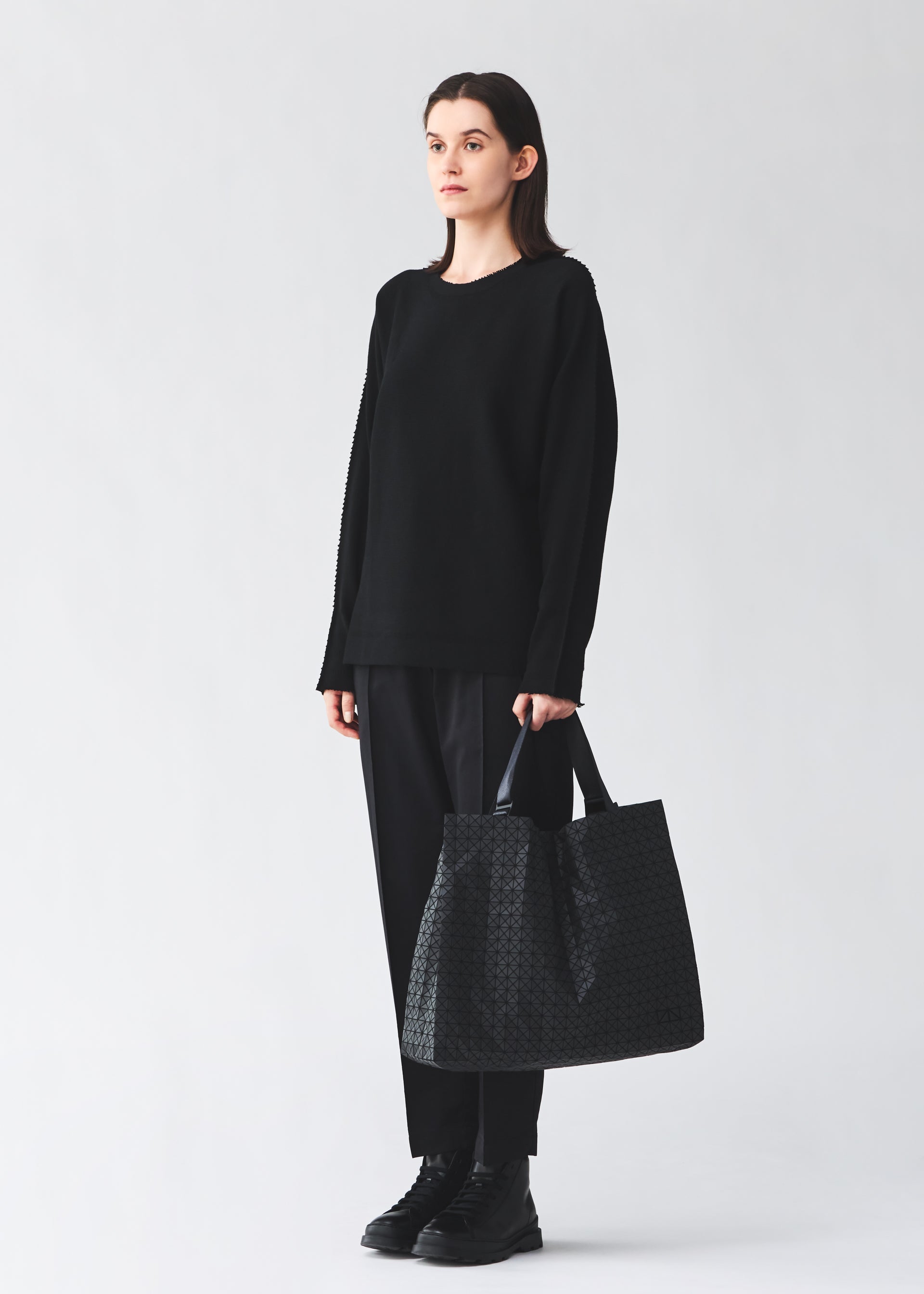A model wears the BAO BAO ISSEY MIYAKE CART cart-tote-matte-black-3.