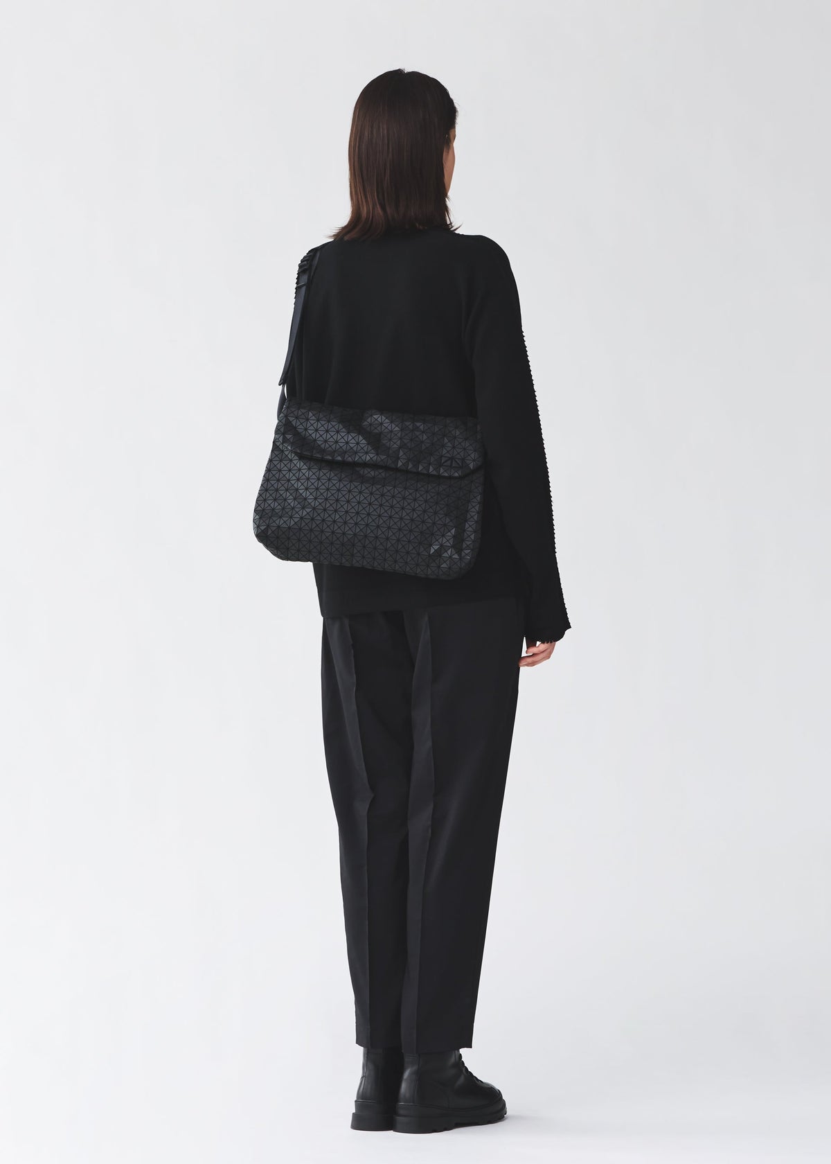 A model wears the BAO BAO ISSEY MIYAKE FROGGY froggy-shoulder-bag-matte-black-2.