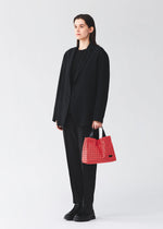 A model wears the BAO BAO ISSEY MIYAKE CART MINI cart-mini-tote-matte-black.