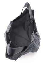 A detail shot of the BAO BAO ISSEY MIYAKE CART REFLECTOR tote.