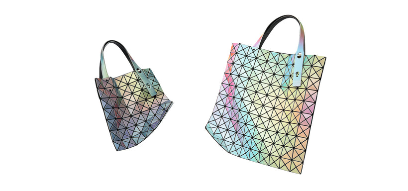 Centre: ILLUSSION Tote in Silver Base and White Base, suspended in mid-air against a white background.