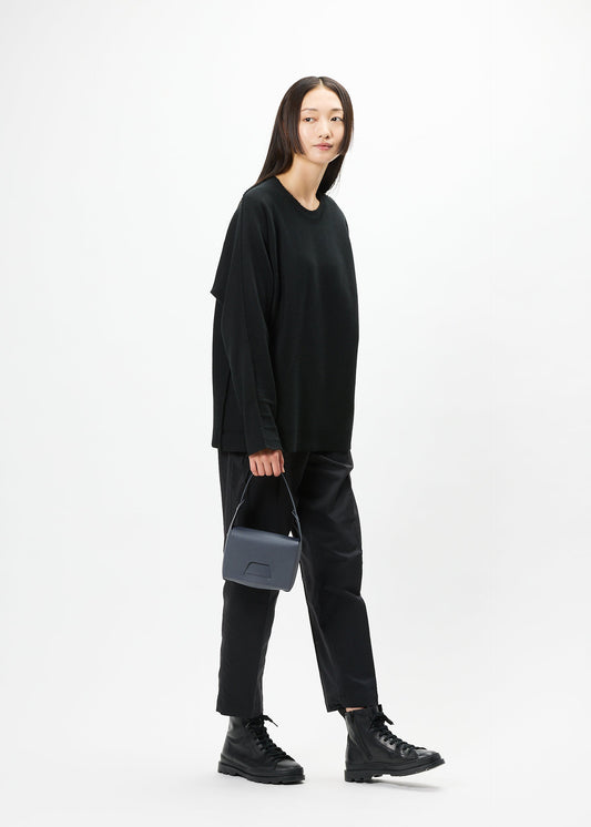 A model wears the GOOD GOODS ISSEY MIYAKE BOX bag.