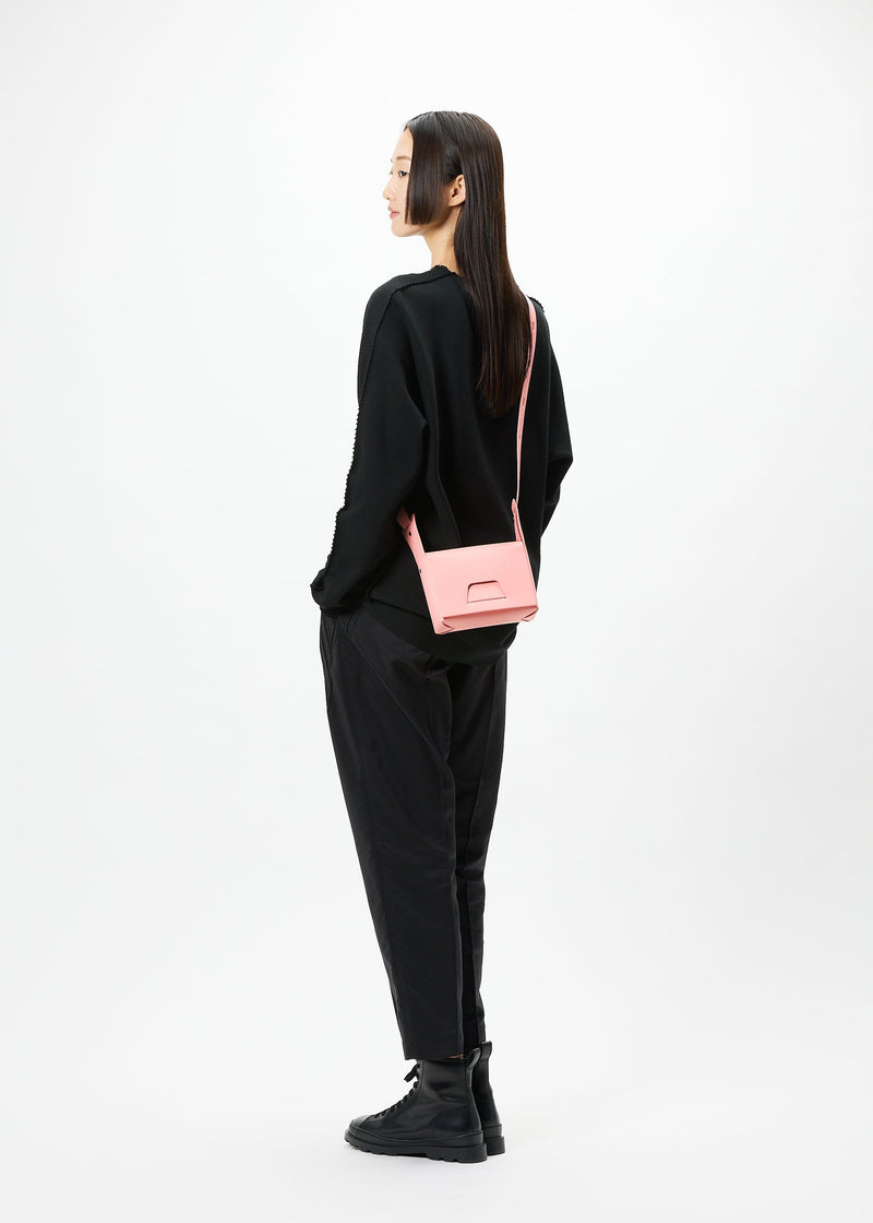 A model wears the GOOD GOODS ISSEY MIYAKE BOX bag.