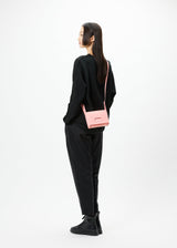 A model wears the GOOD GOODS ISSEY MIYAKE BOX bag.