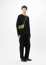 A model wears the GOOD GOODS ISSEY MIYAKE BOX bag.