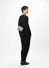 A model wears the GOOD GOODS ISSEY MIYAKE BOX bag.