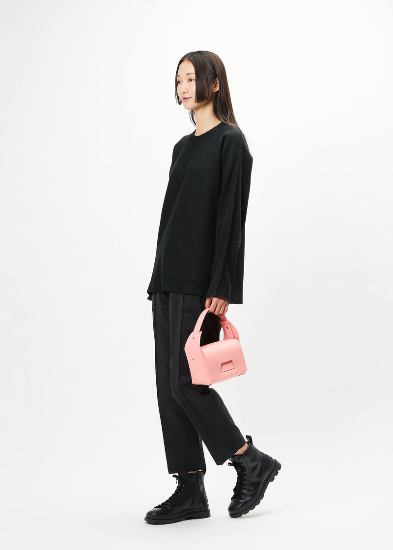 A model wears the GOOD GOODS ISSEY MIYAKE BOX bag.