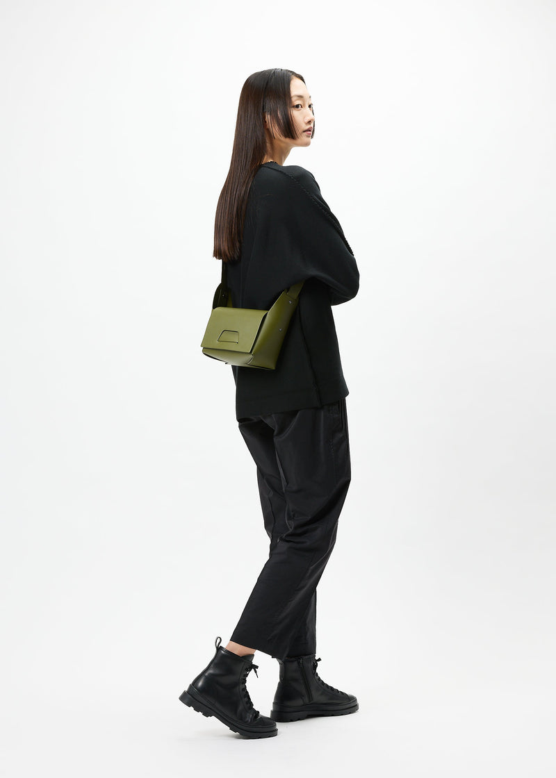 A model wears the GOOD GOODS ISSEY MIYAKE BOX bag.