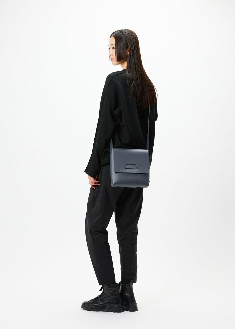 A model wears the GOOD GOODS ISSEY MIYAKE BOX bag.