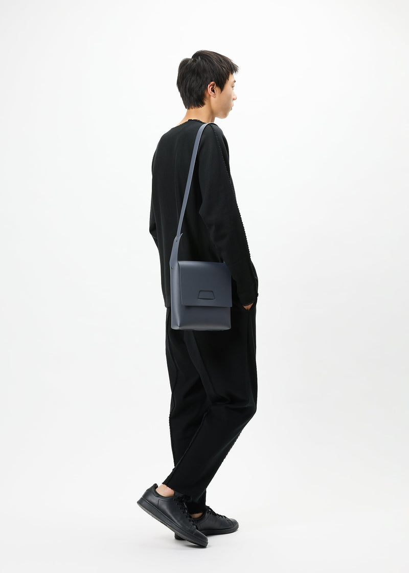 A model wears the GOOD GOODS ISSEY MIYAKE BOX bag.