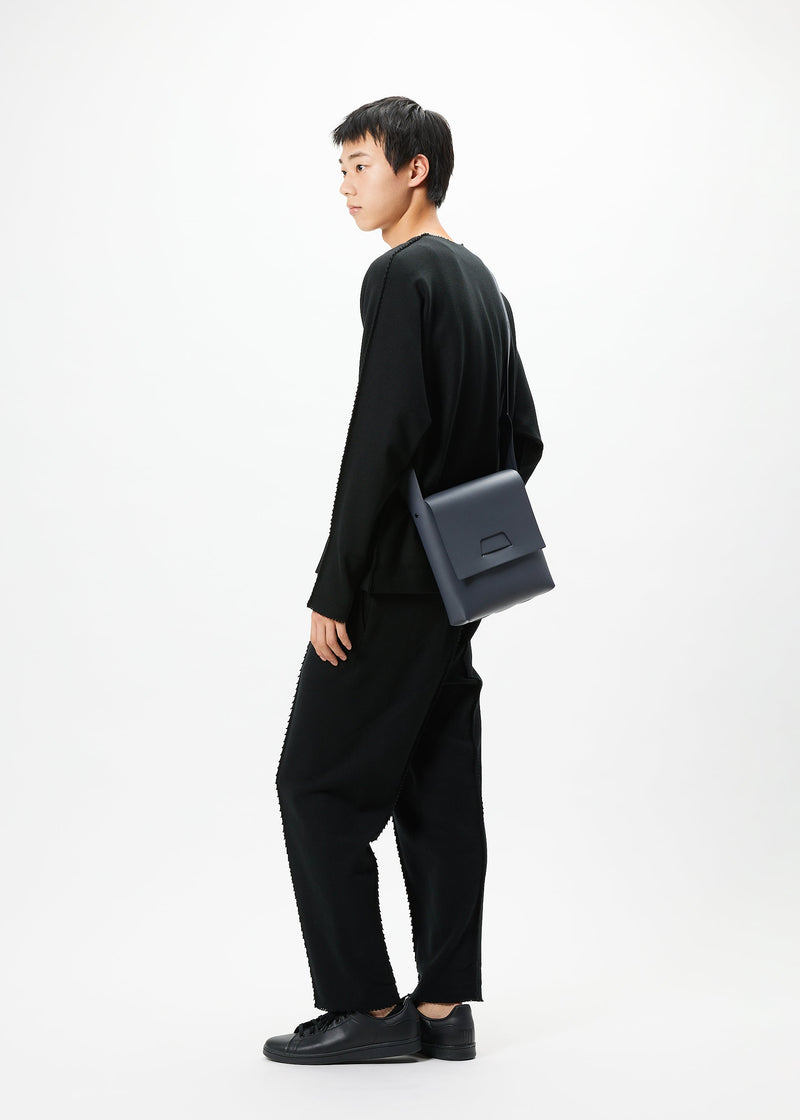 A model wears the GOOD GOODS ISSEY MIYAKE BOX bag.