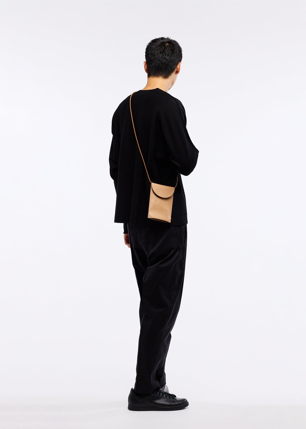 A model wears the GOOD GOODS ISSEY MIYAKE PACKAGE bag.