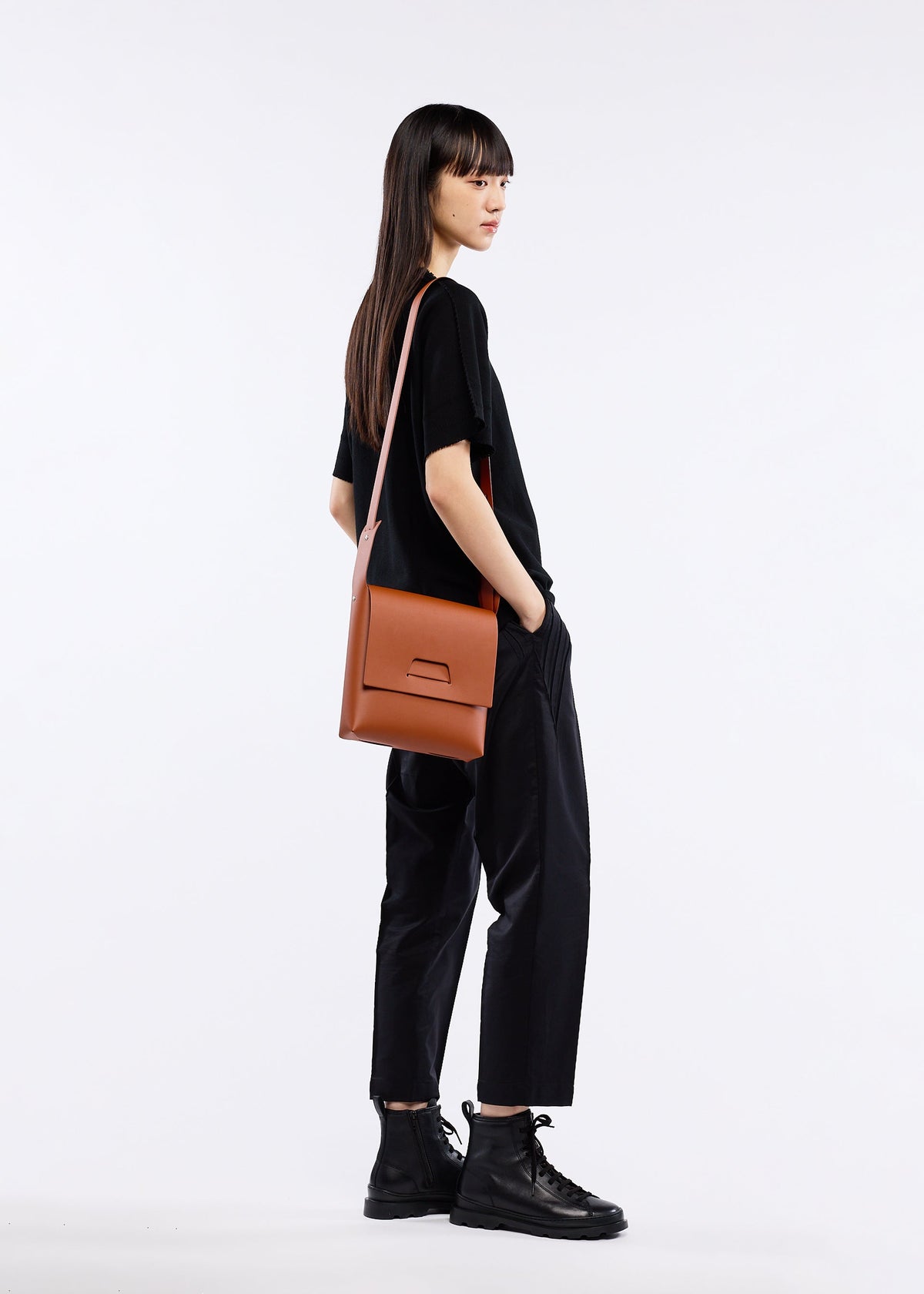A model wears the GOOD GOODS ISSEY MIYAKE BOX bag.