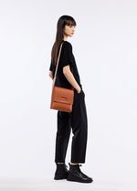 A model wears the GOOD GOODS ISSEY MIYAKE BOX bag.