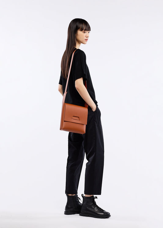 A model wears the GOOD GOODS ISSEY MIYAKE BOX bag.