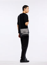 A model wears the GOOD GOODS ISSEY MIYAKE BOX bag.