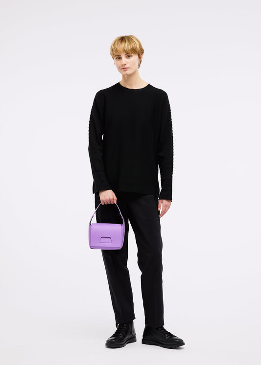 A model wears the GOOD GOODS ISSEY MIYAKE BOX bag.
