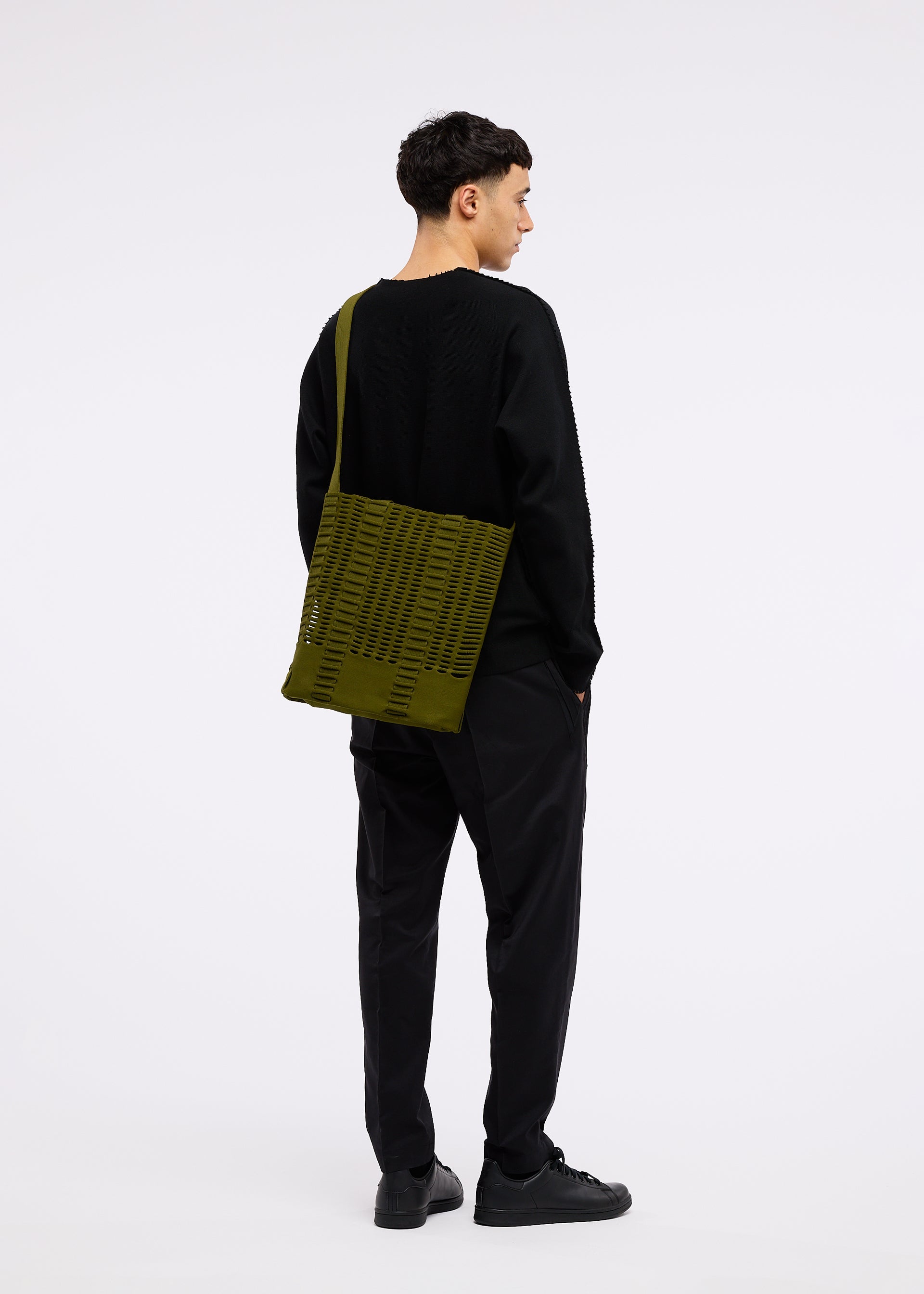 A model wears the GOOD GOODS ISSEY MIYAKE MOKKO MONO bag.