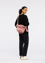 A model wears the GOOD GOODS ISSEY MIYAKE FUWA FUWA bags.