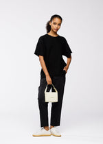 A model wears the GOOD GOODS ISSEY MIYAKE BOX bag.