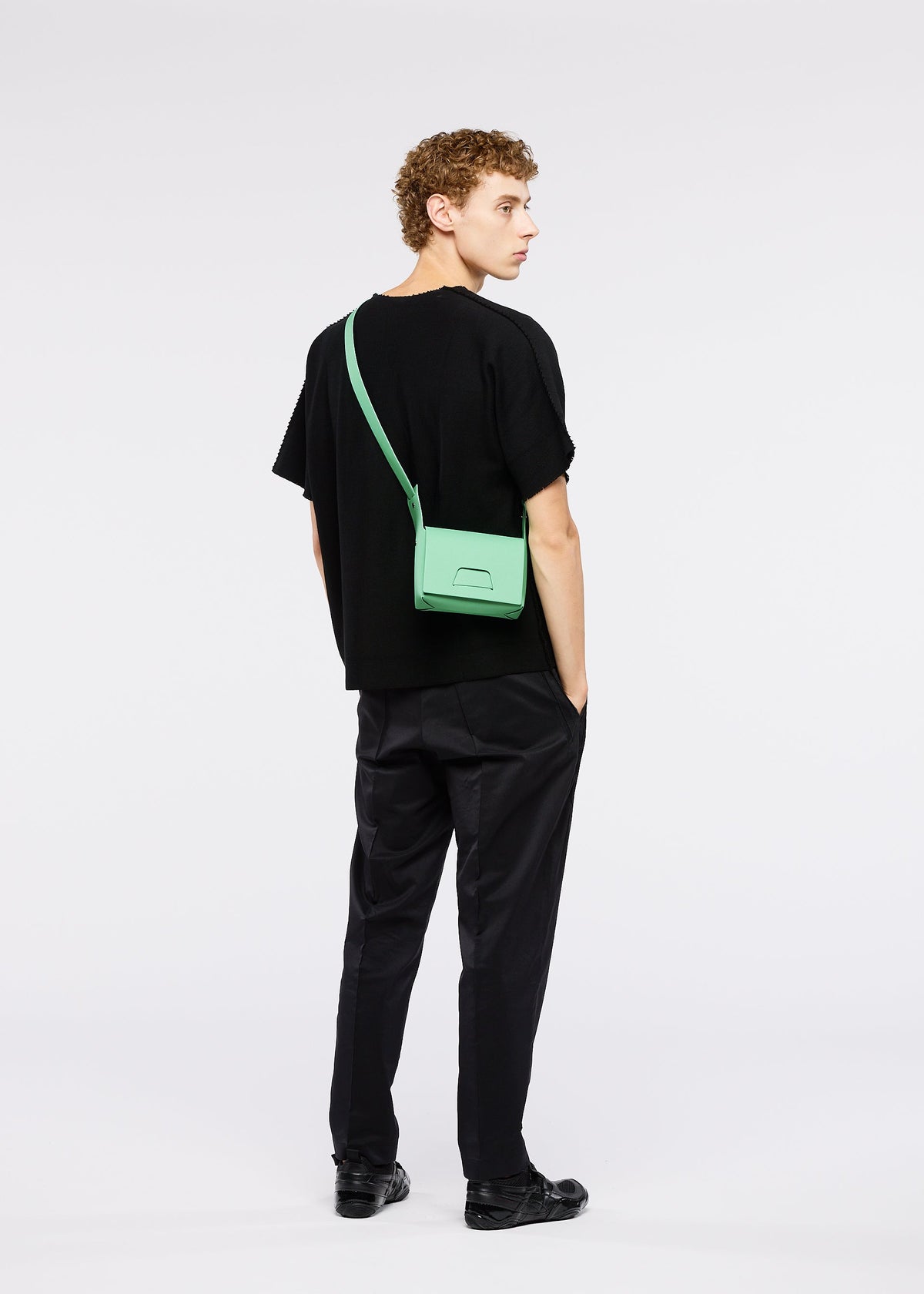 A model wears the GOOD GOODS ISSEY MIYAKE BOX bag.