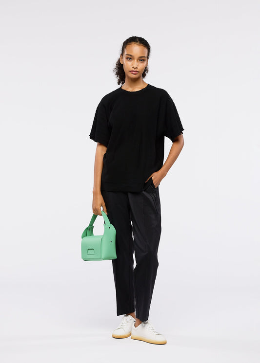 A model wears the GOOD GOODS ISSEY MIYAKE BOX bag.
