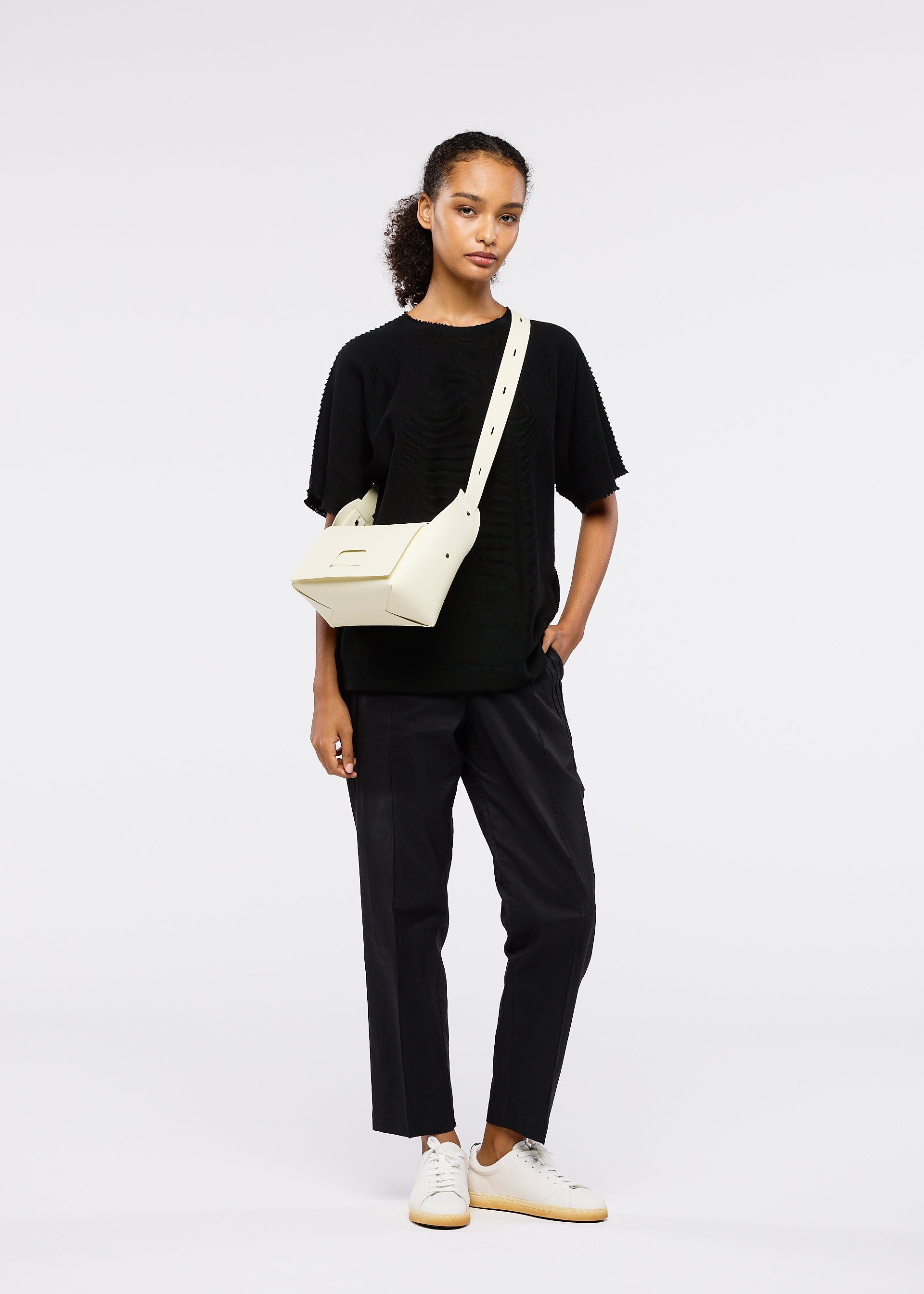 A model wears the GOOD GOODS ISSEY MIYAKE BOX bag.