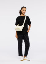 A model wears the GOOD GOODS ISSEY MIYAKE BOX bag.
