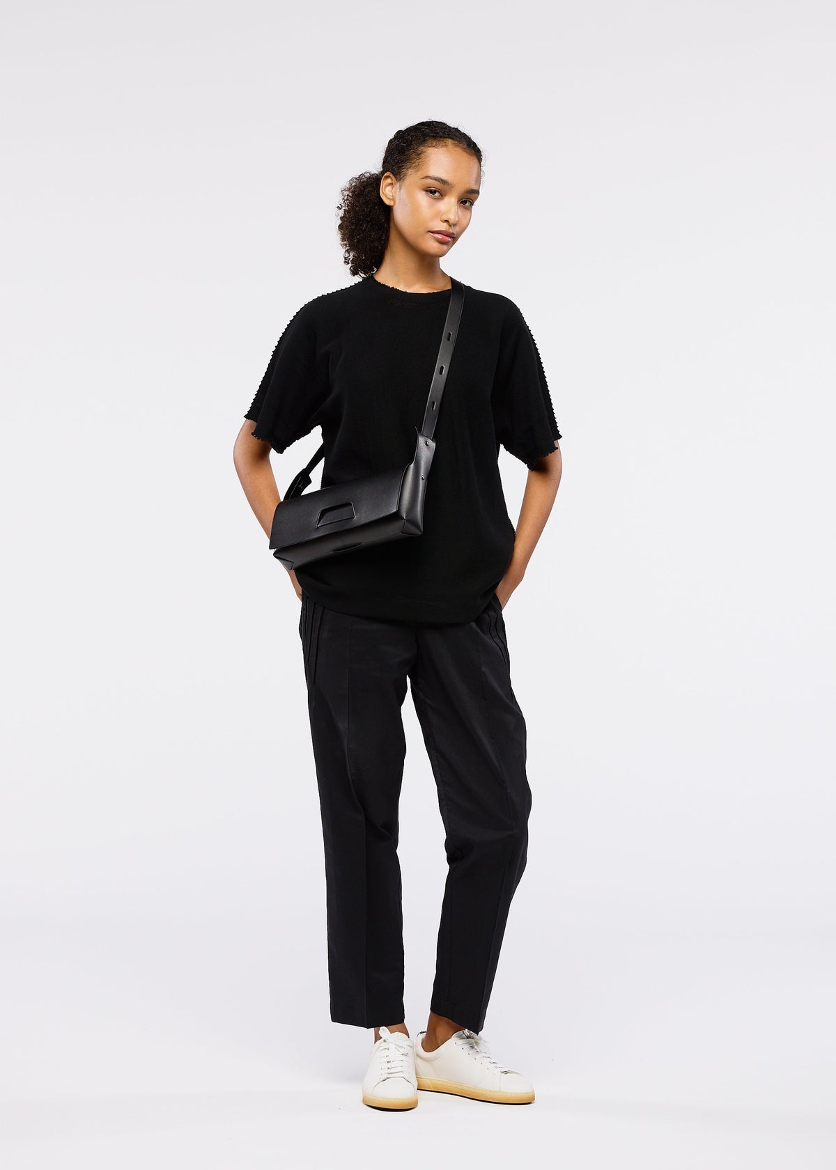 A model wears the GOOD GOODS ISSEY MIYAKE BOX bag.