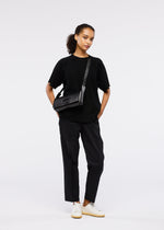A model wears the GOOD GOODS ISSEY MIYAKE BOX bag.
