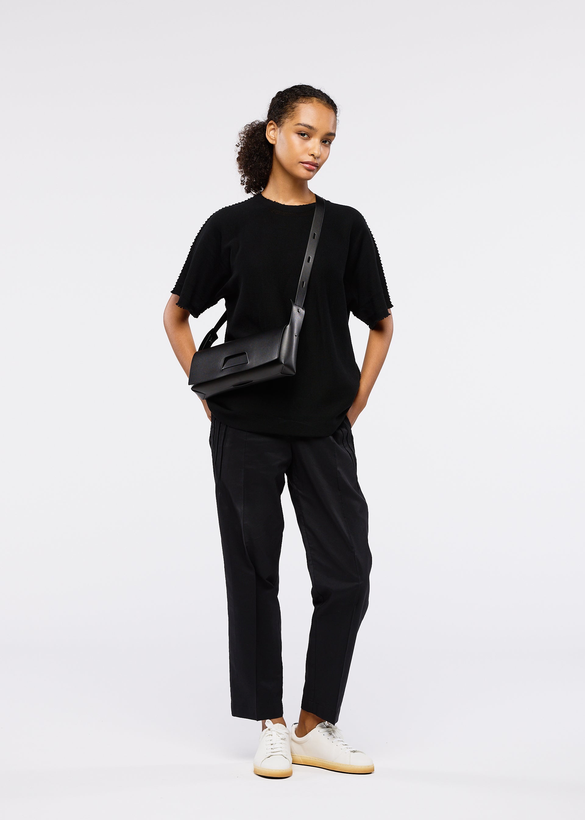 A model wears the GOOD GOODS ISSEY MIYAKE BOX bag.